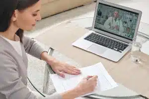 Woman at home on a telemedicine appointment with her doctor
